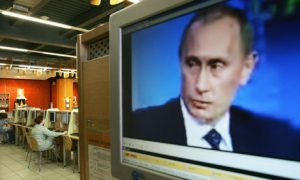 Russian president Vladimir Putin on a computer screen in an internet cafe in Moscow